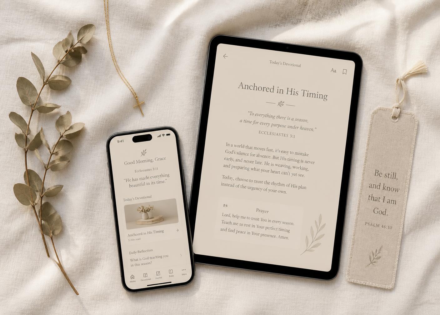 The devotional open on a tablet and smartphone beside a small gold cross